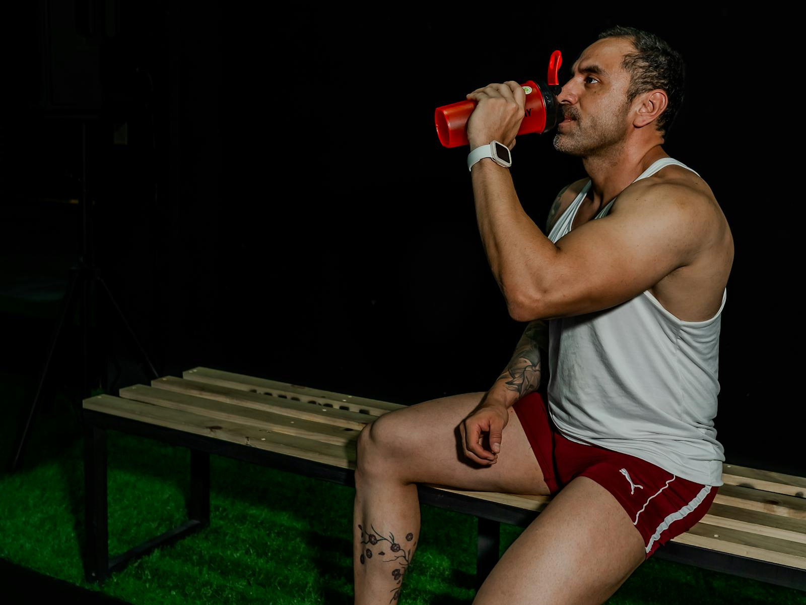 Gym hydration scene with a water bottle during workout